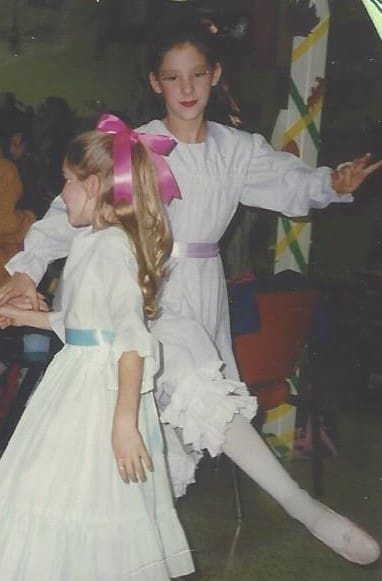 Picture of tall girl and smaller girl dancing with ribbons